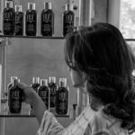 Dark Haired Woman Picking Out Hair Products B&W