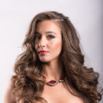 Model with long brown hair and necklace