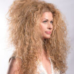 Profile of woman with big blond hair