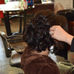 Brunette getting hair curled