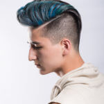 Profile of young male with blue hair