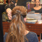 Woman at salon looking in mirror